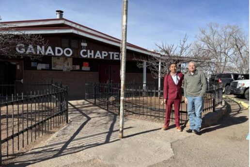 Two people stand outside of Ganado Chapter House of the Navajo Nation in Ganado, AZ.